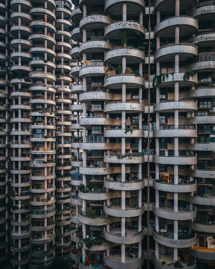 High-rise residential buildings with rounded balconies showcasing glimpses of everyday life in Asia urban settings.