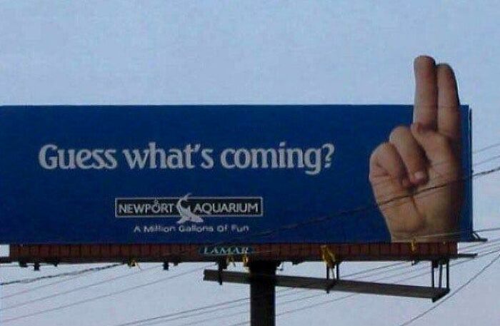 Billboard for Newport Aquarium with a playful hand gesture, showcasing funny and weird billboards people paid for.