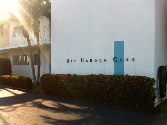 Bay Harbor Club building with sunlight filtering through palm trees representing iconic TV houses in real life.