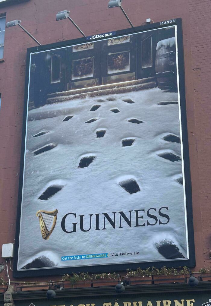 Billboard for Guinness showing unusual footprints in snow, a funny and weird billboard someone actually paid for.