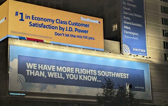 Funny and weird billboards featuring humorous Southwest and United airline ads displayed on building walls at night