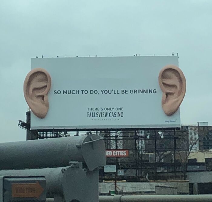 Billboard with oversized ears and text promoting Fallsview Casino, showcasing a funny and weird billboard design concept.