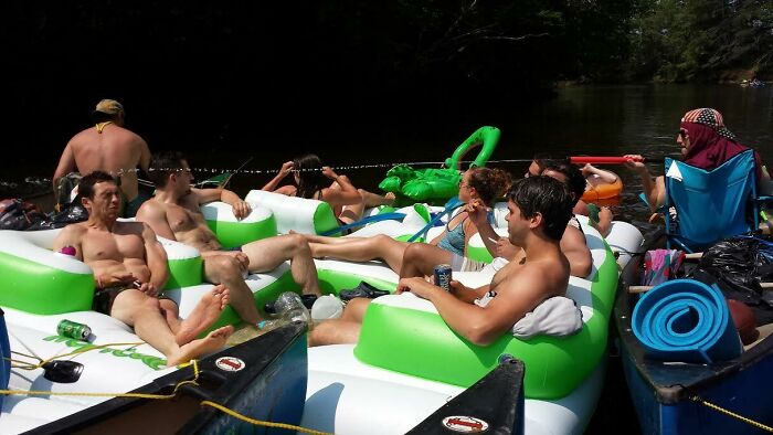 Group of people relaxing on inflatable floats in a river moments before a rope broke disaster.