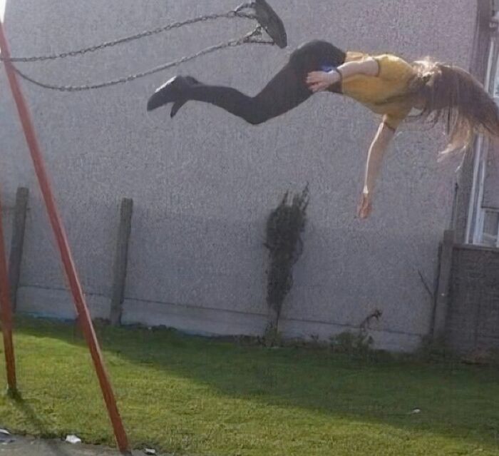 Woman mid-air as rope broke on swing, capturing the moment just before disaster in a backyard setting.