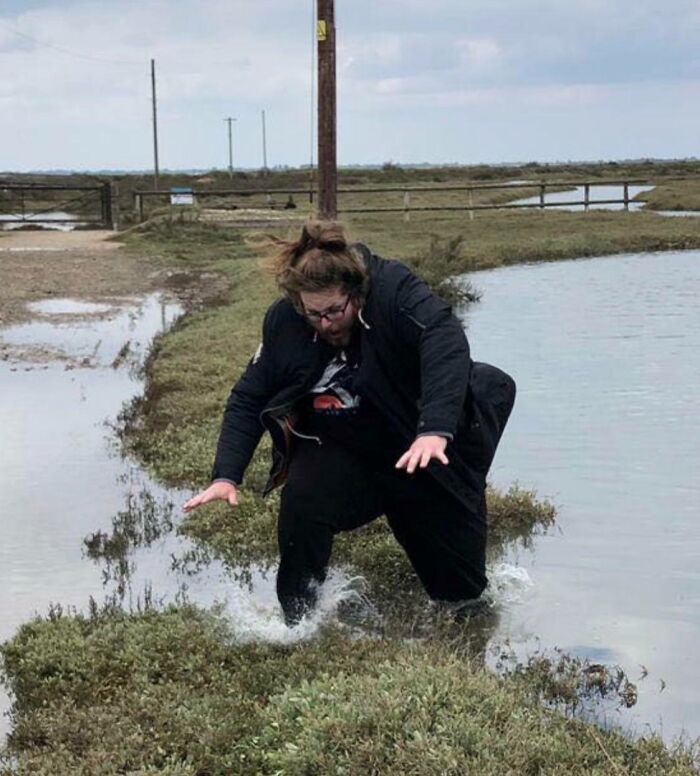 Person falling into water, captured in the moment before disaster struck, illustrating perfect timing and unexpected mishap.