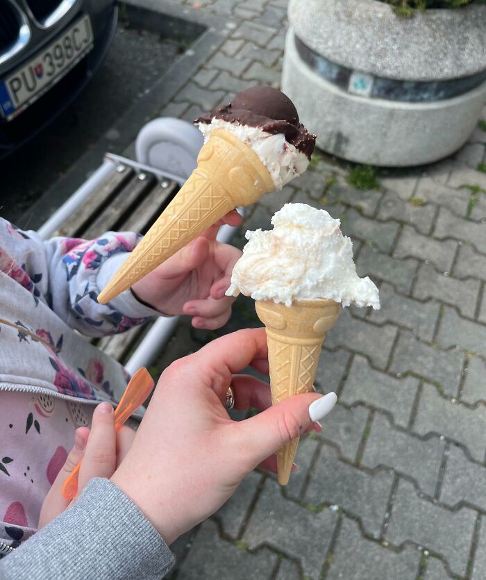Two hands holding melting ice cream cones, capturing the moment the rope broke in a split second before disaster.