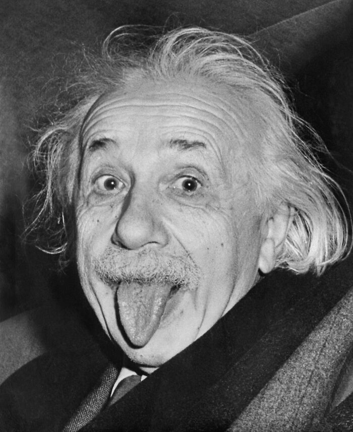 Black and white photo of a famous historical figure making a playful face, related to famous historical quotes misconceptions.