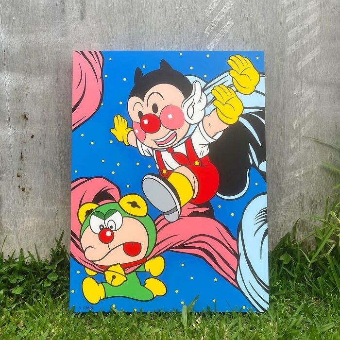 Colorful pop culture and cartoon character mash-ups artwork displayed outdoors on grass and concrete background.