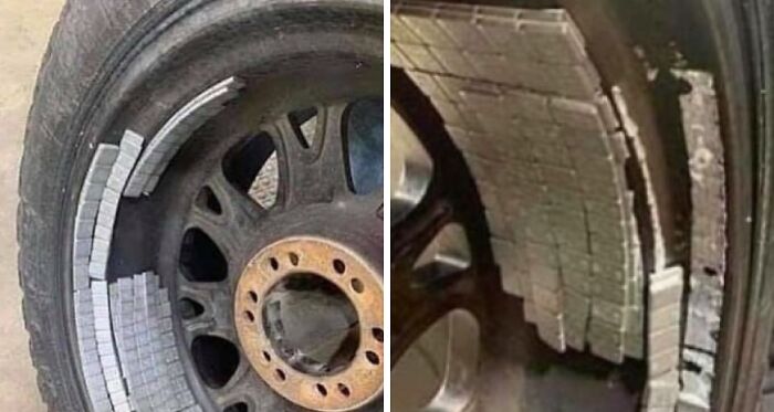 Close-up of a car tire with unusual white tile pieces stuck inside the wheel, showing a mechanic’s unexpected find.
