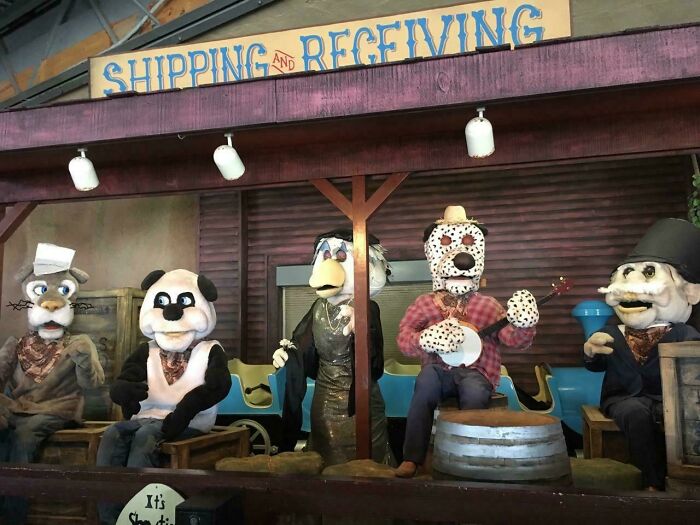 Creepy and unsettling photos showing animatronic characters in a dimly lit shipping and receiving area.