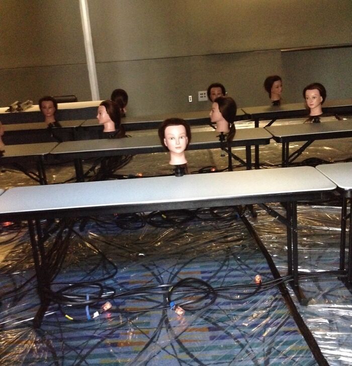 Mannequin heads lined up on tables in a dim room, illustrating creepy and unsettling photos from jobs that should pay more.