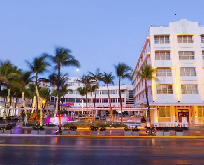 Night view of a brightly lit building with palm trees along the street, unrelated to couple arrested for hotboxing. Night view of a brightly lit building with palm trees along the street, unrelated to couple arrested for hotboxing.