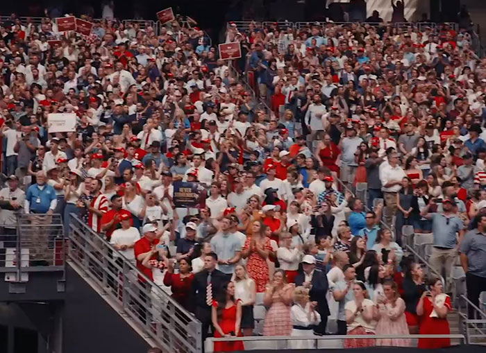 Large crowd at an event, with many attendees standing and clapping, reflecting WWE level stuff energy. Large crowd at an event, with many attendees standing and clapping, reflecting WWE level stuff energy.