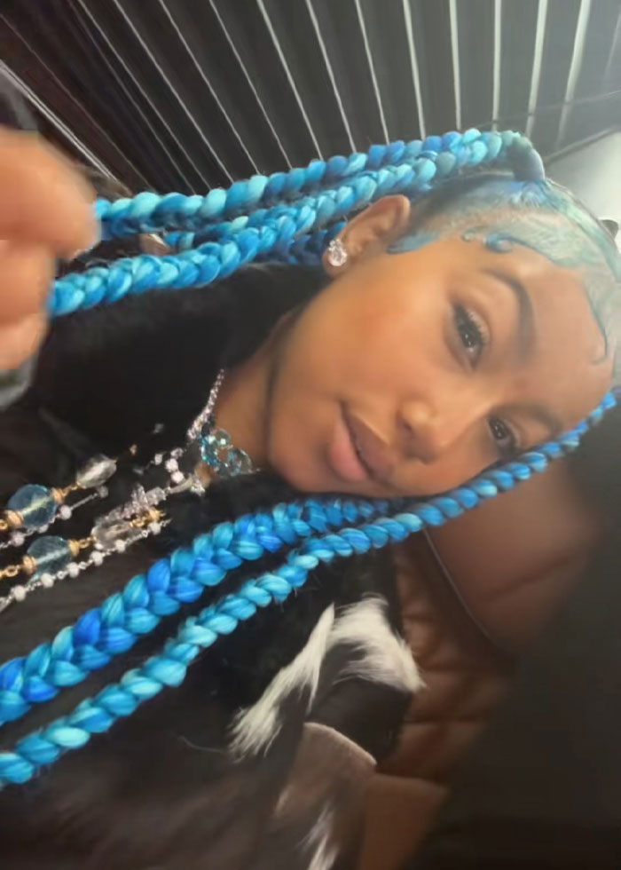Young woman with bright blue braided hair and jewelry, representing Kanye West's public betrayal list SEO keywords. Young woman with bright blue braided hair and jewelry, representing Kanye West's public betrayal list SEO keywords.
