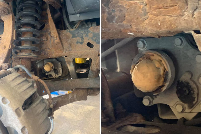 Close-up of rusted car suspension and mechanical parts showing corrosion and wear mechanics had to document.