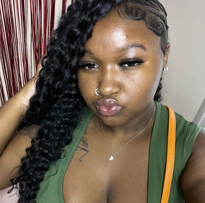 Close-up of a woman with braided hair and nose ring, not related to angry mob ambushes or Walmart employee incidents. Close-up of a woman with braided hair and nose ring, not related to angry mob ambushes or Walmart employee incidents.