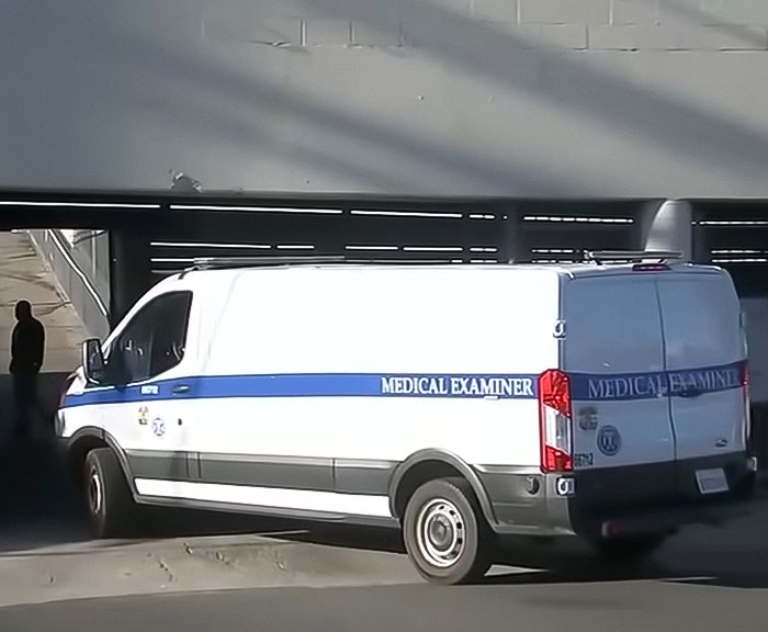Medical examiner van parked under a bridge near an abandoned Tesla linked to a singer in a decomposing body case. Medical examiner van parked under a bridge near an abandoned Tesla linked to a singer in a decomposing body case.