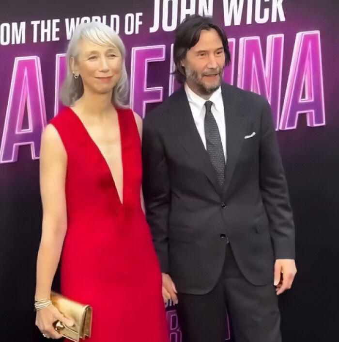 Keanu Reeves and his girlfriend posing at a movie premiere, addressing marriage rumors in a public setting. Keanu Reeves and his girlfriend posing at a movie premiere, addressing marriage rumors in a public setting.