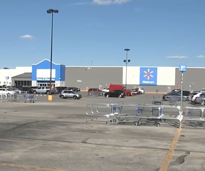 Empty Walmart parking lot with parked cars under clear sky, relating to angry mob ambushing Walmart employee incident. Empty Walmart parking lot with parked cars under clear sky, relating to angry mob ambushing Walmart employee incident.