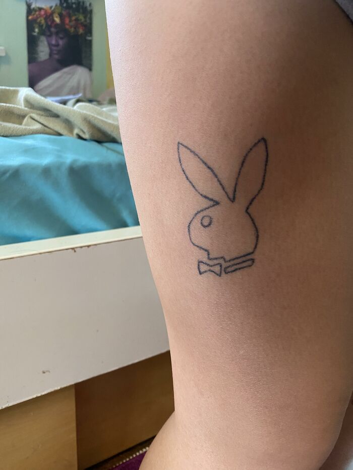 Minimalist outline tattoo of a rabbit logo on a person's arm, representing unusual client tattoo requests revealed by artists.