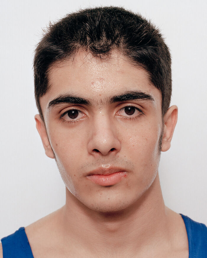 Young boxer sweating and showing signs of a first match, capturing powerful emotions before and after the fight.