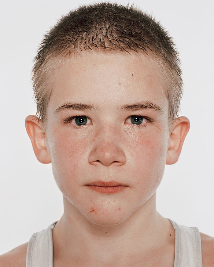 Close-up of a young boxer with a determined expression before his first match in powerful photographs series.