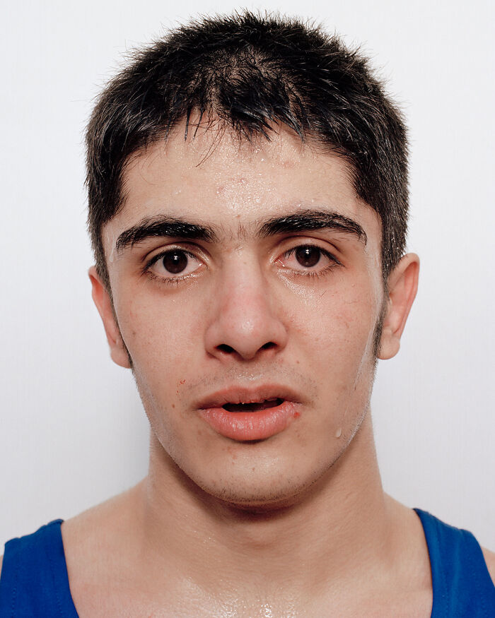 Young boxer sweating and showing signs of a first match, capturing powerful emotions before and after the fight.