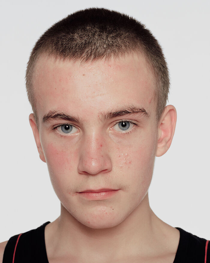 Close-up portrait of a young boxer before his first match showing determination and focus for powerful photographs.