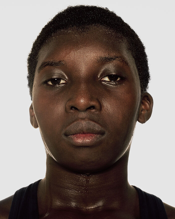Close-up portrait of a young boxer before their first match, showcasing determination and strength in powerful photographs.