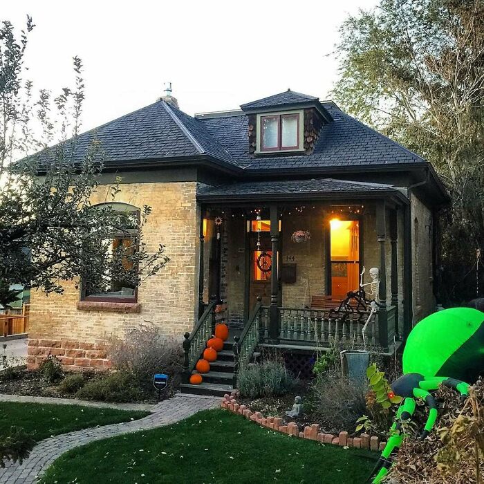 Charming old home with a cozy porch decorated with pumpkins and Halloween decor, showcasing adorable old homes appeal.