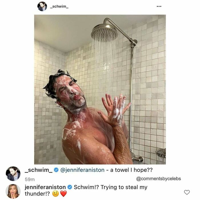 Man covered in soap foam in a shower, with a playful celebrity comment exchange visible below.