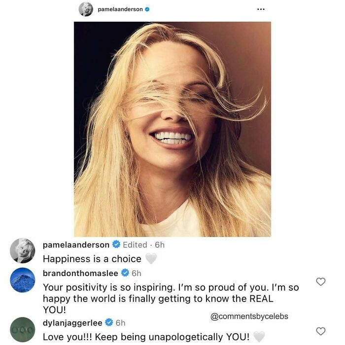 Pamela Anderson smiling with windblown hair, featuring celebrity comments dropping unexpected gems on positivity and authenticity.