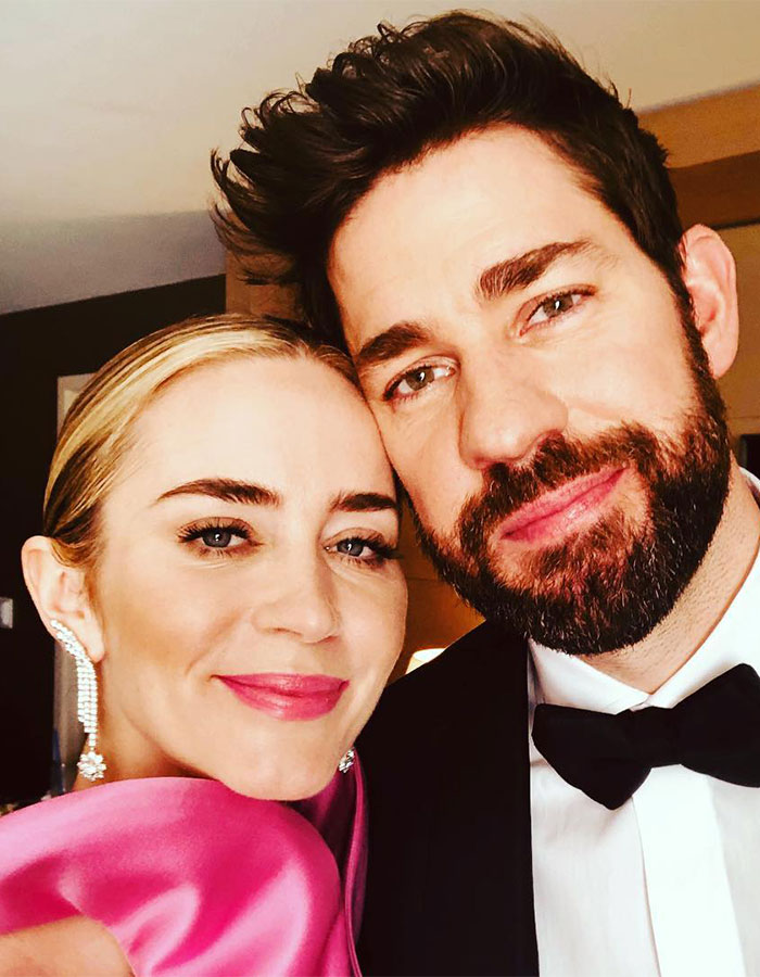 Emily Blunt close-up with a man, smiling at the camera indoors, sparking plastic surgery rumors. Emily Blunt close-up with a man, smiling at the camera indoors, sparking plastic surgery rumors.