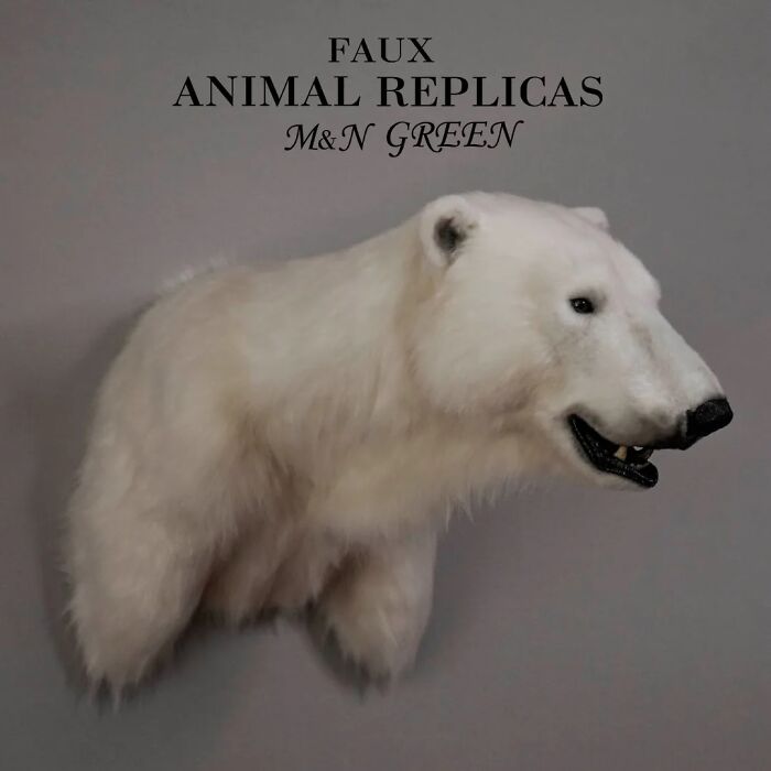 Realistic animal sculpture of a polar bear crafted with synthetic materials without harming wildlife by two artists.