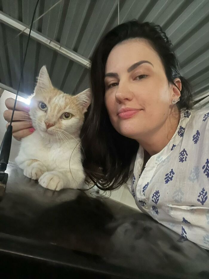 Woman with a stray cat she rescued, part of her project turning a car into a tiny condo for three cats. Woman with a stray cat she rescued, part of her project turning a car into a tiny condo for three cats.