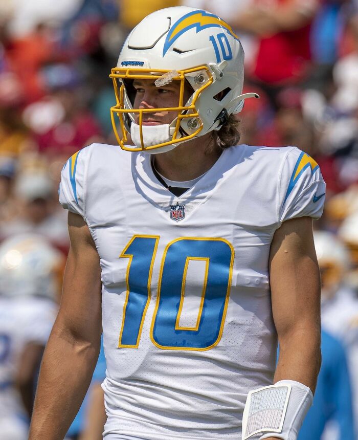 American football player in Chargers uniform during game, representing highest paid athletes 2025.