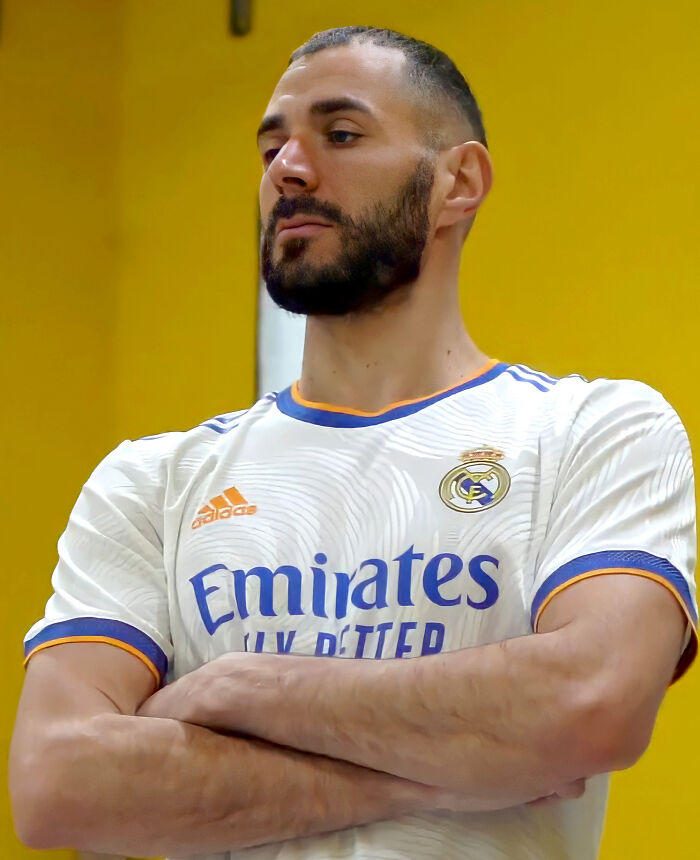 Bearded athlete in a Real Madrid jersey posing confidently, representing highest paid athletes of 2025 in sports.