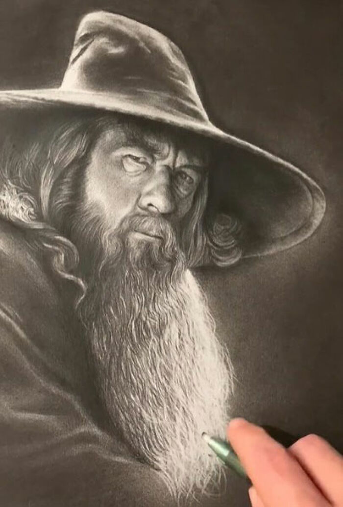 Hand drawing an incredible pencil portrait of an older man with a beard and wide-brimmed hat capturing every tiny detail.