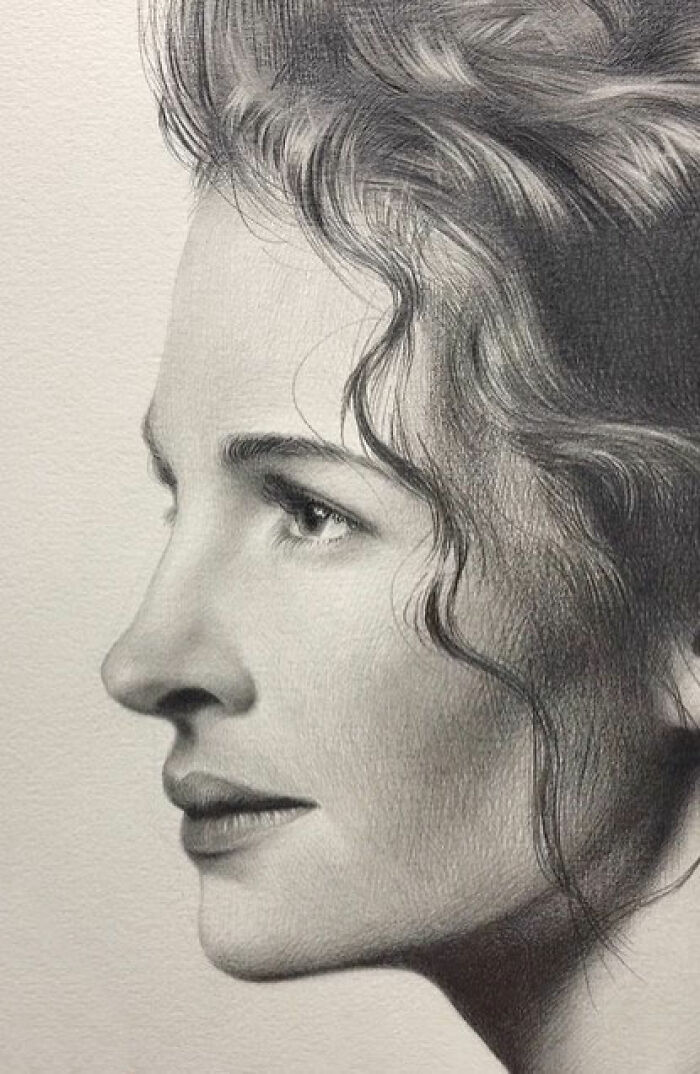 Realistic pencil portrait of a woman in profile, showcasing incredible detail in hair texture and facial features.