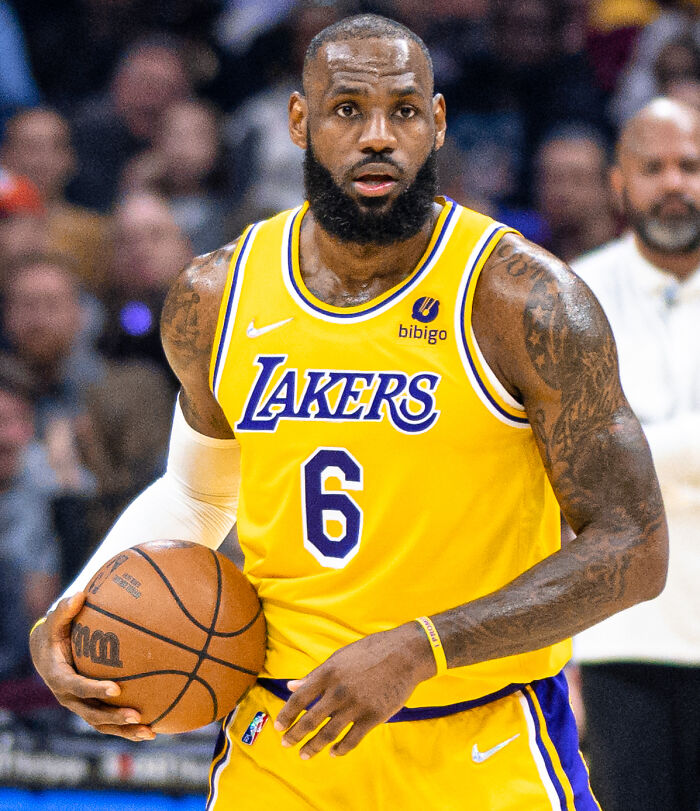 LeBron James playing basketball in a Lakers uniform, showcasing one of the highest paid athletes of 2025.