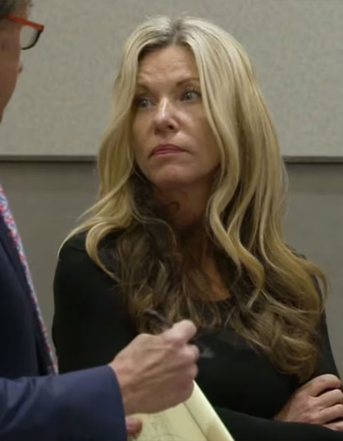 Woman with long blonde hair and black top listens intently during a conversation about convicted doomsday cult mom. Woman with long blonde hair and black top listens intently during a conversation about convicted doomsday cult mom.
