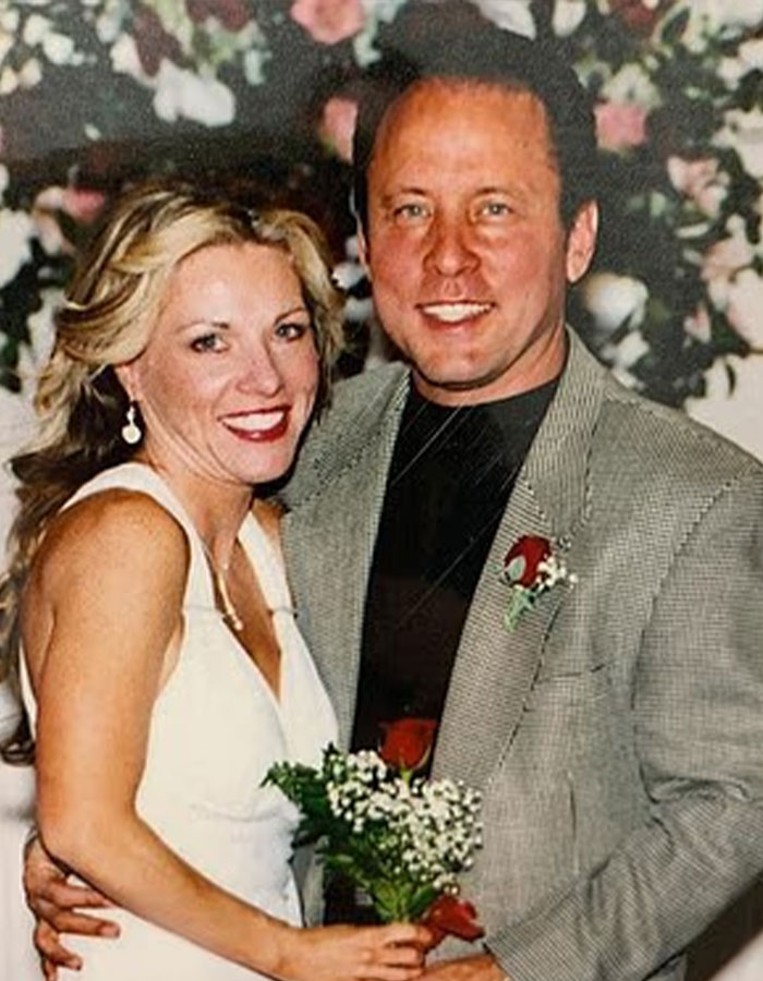 Couple posing with flowers, highlighting convicted doomsday cult mom in a vintage, intimate setting. Couple posing with flowers, highlighting convicted doomsday cult mom in a vintage, intimate setting.