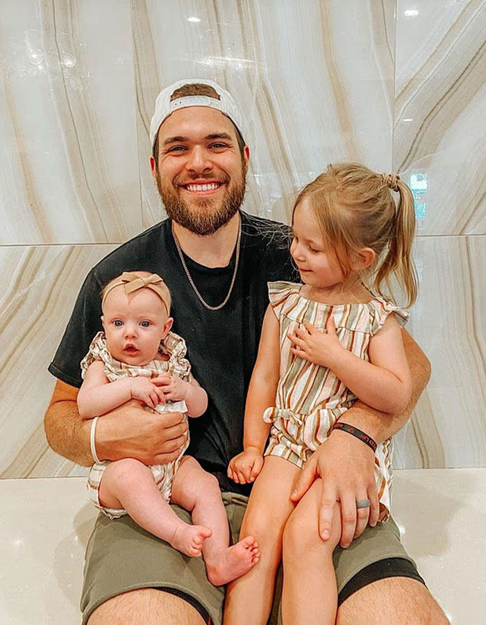 Man sitting with two young children, representing surviving son in story about doomsday cult mom at CrimeCon. Man sitting with two young children, representing surviving son in story about doomsday cult mom at CrimeCon.