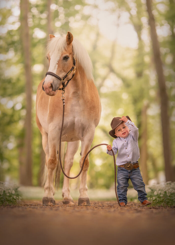 Young girl hugging a white unicorn pet in a field, a creative pet photo with heartwarming tones winning photography awards.
