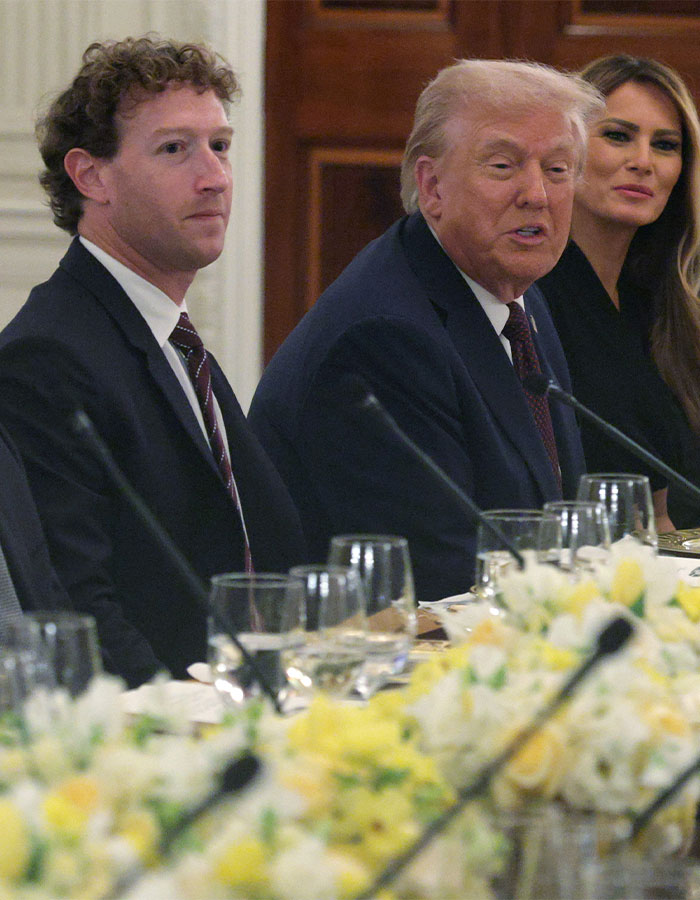 Mark Zuckerberg sitting beside Donald Trump and Melania Trump at a formal event with a floral centerpiece on the table. Mark Zuckerberg sitting beside Donald Trump and Melania Trump at a formal event with a floral centerpiece on the table.