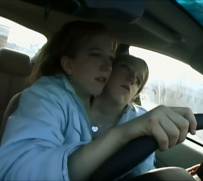 Conjoined twins Abby and Brittany sitting together in a car, expert revealing insights about who would be the mom. Conjoined twins Abby and Brittany sitting together in a car, expert revealing insights about who would be the mom.