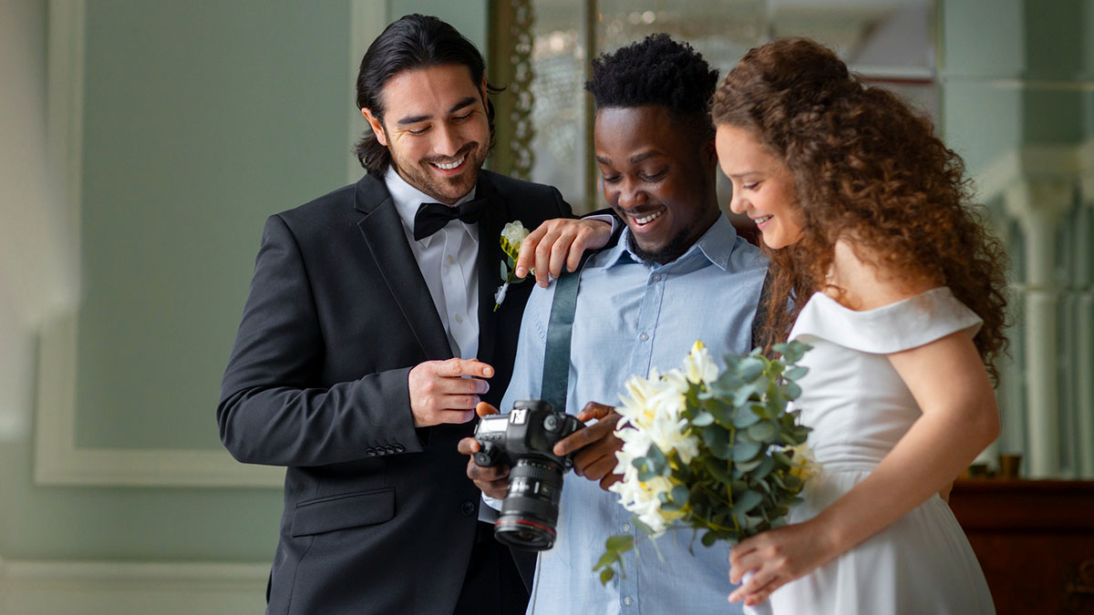 Photographer showing wedding photos to bride and groom, capturing school project moments at university event.