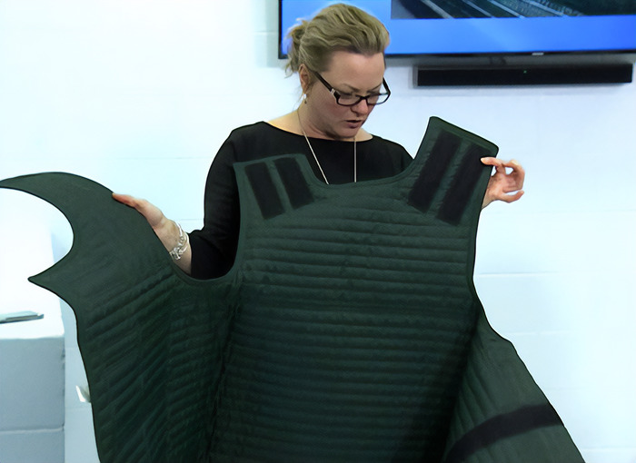Woman in courtroom holding up a protective vest as people notice an eerie detail related to Tyler Robinson court case Woman in courtroom holding up a protective vest as people notice an eerie detail related to Tyler Robinson court case
