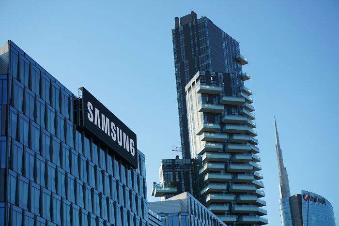 Modern city buildings under clear sky, focus on Samsung sign and high-rise architecture reflecting urban profession themes.
