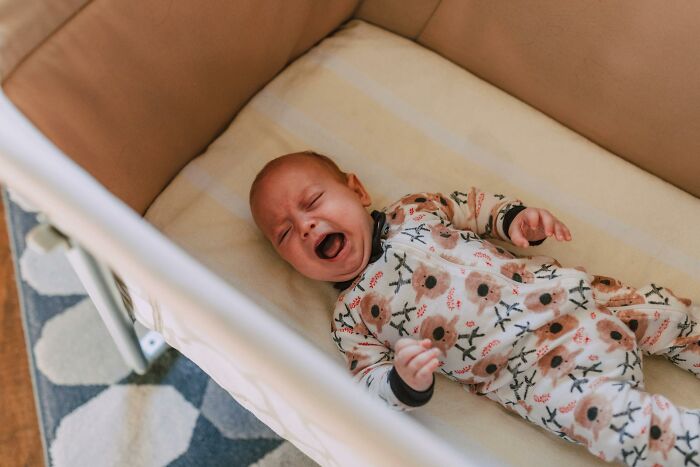 Crying baby lying alone in crib, illustrating dad takes care of son for the first time but forgets diaper change and feeding. Crying baby lying alone in crib, illustrating dad takes care of son for the first time but forgets diaper change and feeding.